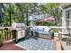 This outdoor deck features a grill, wicker sofa, blue patterned rug and egg chair providing a perfect outdoor living space at 1733 James Basford Pl, Mount Pleasant, SC 29466