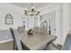 Elegant dining room with a modern chandelier and ample seating for Gathering gatherings at 1733 James Basford Pl, Mount Pleasant, SC 29466