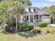Charming home with a welcoming front porch, lush landscaping, and an attached garage, ideal for comfortable living at 1733 James Basford Pl, Mount Pleasant, SC 29466