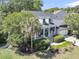 Picturesque home featuring a manicured lawn, inviting front porch, and convenient attached garage, set in a serene landscape at 1733 James Basford Pl, Mount Pleasant, SC 29466