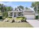 Beautiful home with a lovely front porch, well-maintained landscaping, and a convenient two-car garage, offering curb appeal at 1733 James Basford Pl, Mount Pleasant, SC 29466