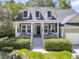 Inviting home featuring a classic front porch, dormer windows, and meticulously manicured landscaping, creating a warm ambiance at 1733 James Basford Pl, Mount Pleasant, SC 29466