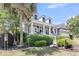Charming two-story home with dormer windows, a covered front porch, and lush landscaping at 1733 James Basford Pl, Mount Pleasant, SC 29466