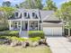 Charming home featuring a welcoming porch, landscaped front yard, and a two-car garage at 1733 James Basford Pl, Mount Pleasant, SC 29466