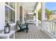 Inviting front porch with comfortable seating and a porch swing, ideal for relaxing outdoors at 1733 James Basford Pl, Mount Pleasant, SC 29466
