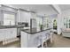 Modern kitchen with white cabinets, a large island, and stainless steel appliances at 1733 James Basford Pl, Mount Pleasant, SC 29466
