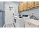 Functional laundry room with washer, dryer, utility sink, and ample cabinet space, plus access to outside at 1733 James Basford Pl, Mount Pleasant, SC 29466