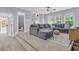 Open living room with a gray sectional couch, carpet, and views into the adjacent bathroom at 1733 James Basford Pl, Mount Pleasant, SC 29466