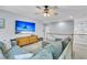 This light-filled living room has a modern console, large TV, sectional sofa and a staircase to the second floor at 1733 James Basford Pl, Mount Pleasant, SC 29466