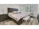 Comfortable main bedroom with large bed, sitting area, and natural light from a beautiful bay window at 1733 James Basford Pl, Mount Pleasant, SC 29466