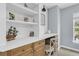 This dedicated office space has built-in shelving, cabinets, a desk and a comfortable chair for focused work at 1733 James Basford Pl, Mount Pleasant, SC 29466