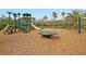 Community playground with slides, swings, and a merry-go-round on wood chip groundcover at 1733 James Basford Pl, Mount Pleasant, SC 29466