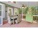 Outdoor porch features a dining table with chairs and a hanging swing seat for relaxing in the fresh air at 1733 James Basford Pl, Mount Pleasant, SC 29466