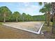 A sand volleyball court is surrounded by lush landscaping and ready for community fun at 1733 James Basford Pl, Mount Pleasant, SC 29466