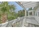 Balcony with white pergola, tropical plants, and views, perfect for outdoor enjoyment and relaxation at 1781 Brittlebush Ln, Johns Island, SC 29455