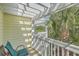 Balcony with outdoor seating, a white pergola, and lush tropical landscaping, creating a relaxing retreat at 1781 Brittlebush Ln, Johns Island, SC 29455