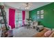 Bright bedroom featuring green accent wall, natural light, and a ceiling fan at 1781 Brittlebush Ln, Johns Island, SC 29455