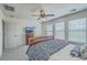 Bedroom with dark wood sleigh bed, ceiling fan, three windows, and neutral tones, offering comfort at 1781 Brittlebush Ln, Johns Island, SC 29455
