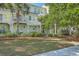 Attractive two-story home with a well-maintained lawn, mature trees, and a cozy balcony at 1781 Brittlebush Ln, Johns Island, SC 29455