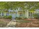Charming two-story home features a manicured lawn, walkway lighting, and a private second-floor balcony at 1781 Brittlebush Ln, Johns Island, SC 29455