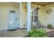 Welcoming front porch with comfortable seating, stylish lighting, and attractive landscaping at 1781 Brittlebush Ln, Johns Island, SC 29455