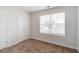 Bright bedroom features neutral carpet, a window with blinds, and a double-door closet at 1816 Casein St, Summerville, SC 29483