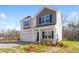Charming two-story home with a two car garage, stone accents, and a manicured lawn at 1816 Casein St, Summerville, SC 29483