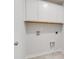 Clean laundry room features white cabinets, tile floor and washer and dryer hookups at 1816 Casein St, Summerville, SC 29483