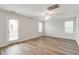Spacious living room with neutral paint, wood-look floors, ceiling fan, and ample natural light at 1816 Casein St, Summerville, SC 29483