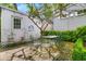 Charming brick patio with outdoor seating, surrounded by lush greenery at 184 Ashley Ave, Charleston, SC 29403