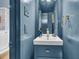 Charming powder room with a blue vanity, elegant fixtures, and classic details at 184 Ashley Ave, Charleston, SC 29403
