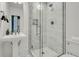 Modern bathroom with a glass-enclosed shower, pedestal sink, and white marble tile at 184 Ashley Ave, Charleston, SC 29403