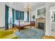 Spacious bedroom featuring a four-poster bed, fireplace, chandelier and tranquil color scheme at 184 Ashley Ave, Charleston, SC 29403