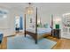 Spacious bedroom featuring a four-poster bed, hardwood floors, and stylish lighting at 184 Ashley Ave, Charleston, SC 29403