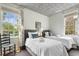 Inviting bedroom featuring two twin beds, decorative wallpaper, and plenty of natural light at 184 Ashley Ave, Charleston, SC 29403