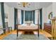 Bright bedroom features a four-poster bed, bay windows, and an inviting, airy atmosphere at 184 Ashley Ave, Charleston, SC 29403
