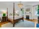 Bright bedroom with a four-poster bed, fireplace, and large window for a cozy atmosphere at 184 Ashley Ave, Charleston, SC 29403