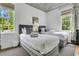 Comfortable bedroom with twin beds, elegant grey decor, and decorative ceiling detail at 184 Ashley Ave, Charleston, SC 29403