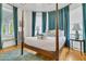 Bedroom features a four-poster bed, bright natural light, and a serene, relaxing ambiance at 184 Ashley Ave, Charleston, SC 29403