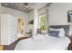 Comfortable bedroom featuring a twin bed, an en suite bathroom, and decorative ceiling at 184 Ashley Ave, Charleston, SC 29403