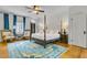 Bright bedroom with blue accents, featuring a four-poster bed and hardwood floors at 184 Ashley Ave, Charleston, SC 29403