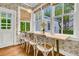 Sunlit dining area with table, chairs, and view to the outdoors at 184 Ashley Ave, Charleston, SC 29403