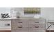 Charming dresser with artwork, accent lamp, and seating area with natural light at 184 Ashley Ave, Charleston, SC 29403