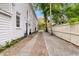 Long driveway leading to a house with lush greenery and a well-kept fence at 184 Ashley Ave, Charleston, SC 29403
