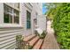 Charming entryway with brick steps and a blue door surrounded by lush greenery at 184 Ashley Ave, Charleston, SC 29403