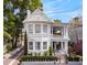 Charming white two-story home with a spacious front porch and well-maintained landscaping at 184 Ashley Ave, Charleston, SC 29403