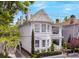 Charming two-story white home with a brick driveway and well-manicured landscaping at 184 Ashley Ave, Charleston, SC 29403