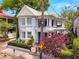 Two-story home with charming exterior featuring a wraparound porch and lush landscaping at 184 Ashley Ave, Charleston, SC 29403