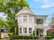 Beautiful two-story home featuring a charming front porch and manicured garden at 184 Ashley Ave, Charleston, SC 29403