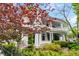 Beautiful exterior shot of a two-story home with lush landscaping and a charming front porch at 184 Ashley Ave, Charleston, SC 29403